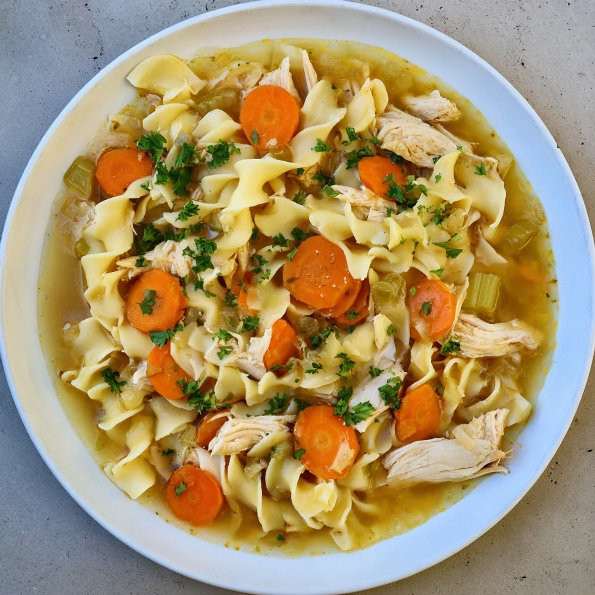 Hearty Cozy Chicken Noodle Soup, with perfectly cooked noodles and tender chicken, ready to warm you.