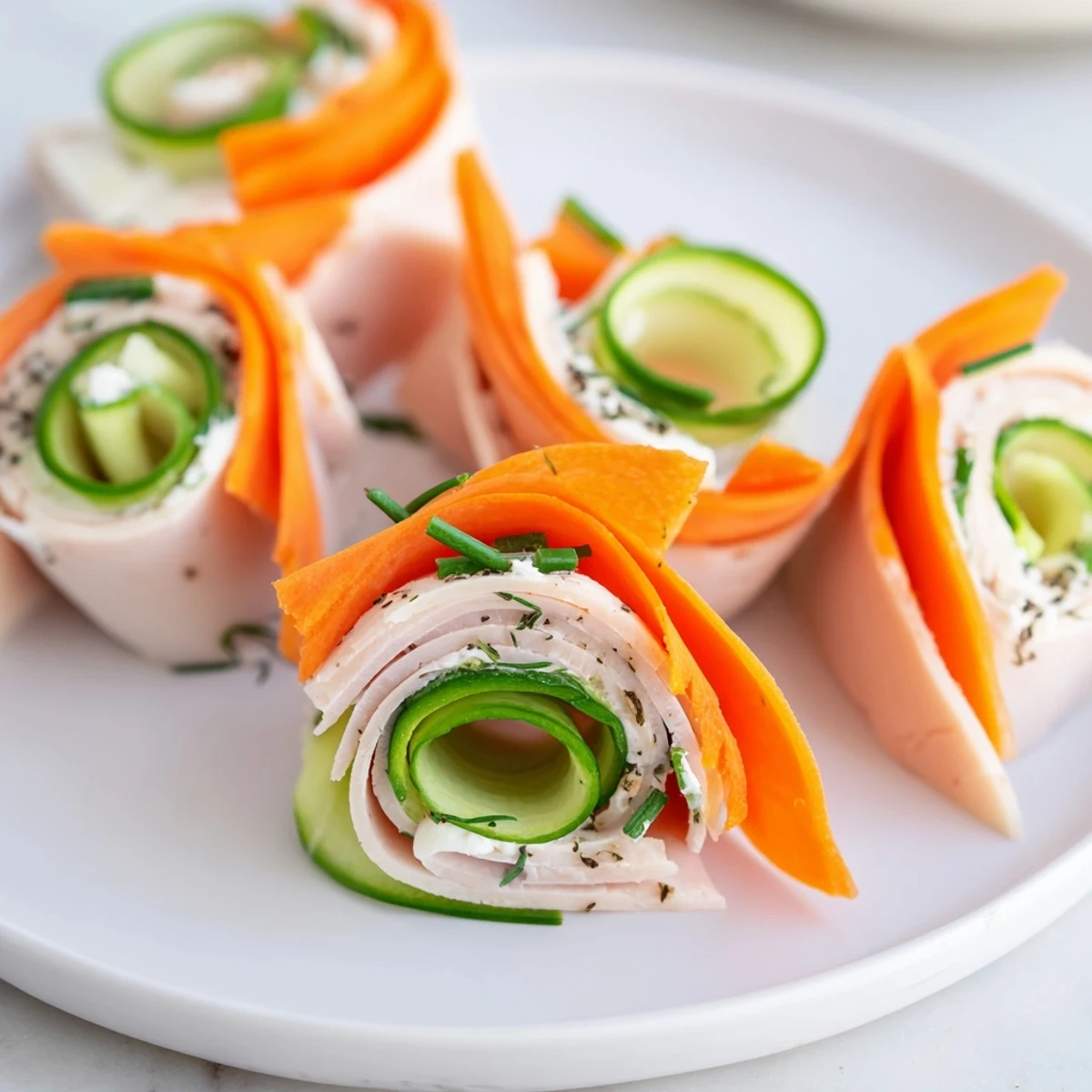 The Ribbon Dancer appetizer: fresh carrot and cucumber ribbons hug savory smoked turkey rolls, ready to serve.