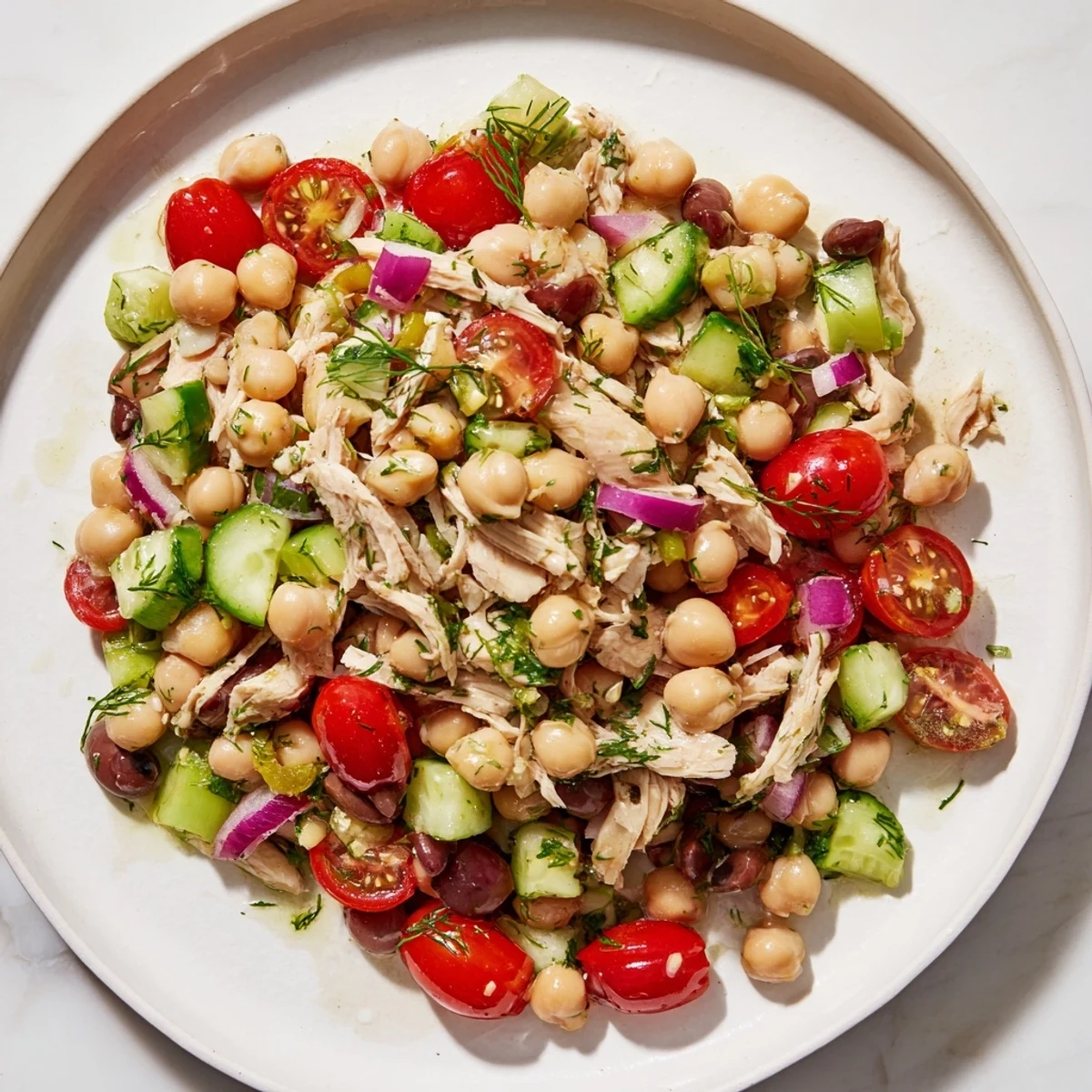 Hearty and delicious Dense Bean Salad with Lemon-Dill Chicken boasts tender chicken and fresh vegetables.