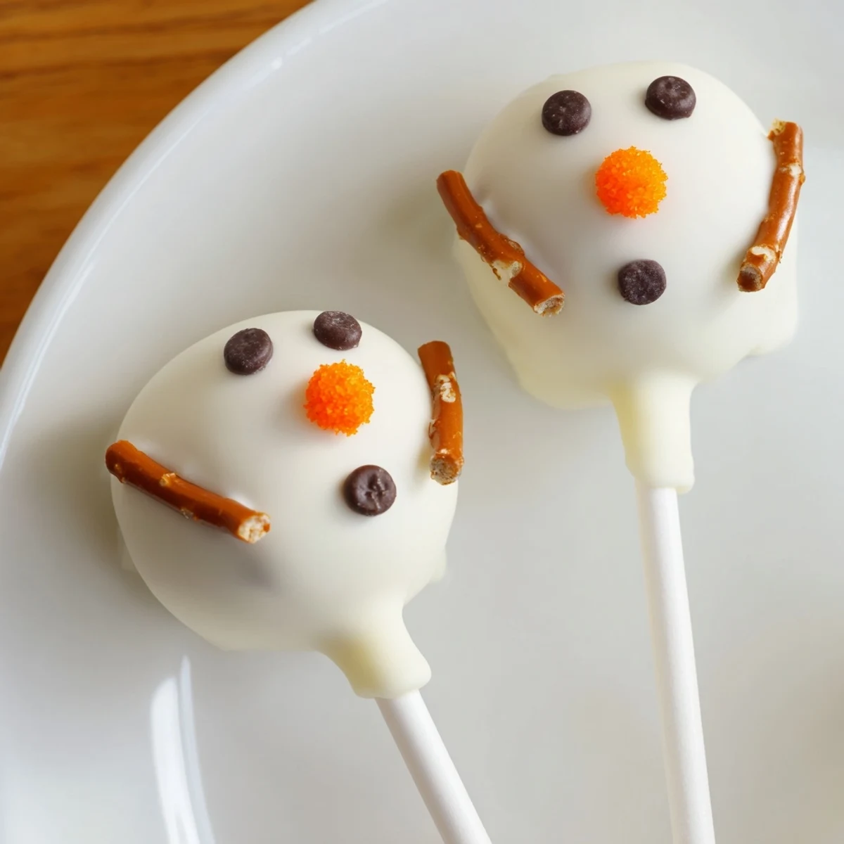 Round and ready to eat, homemade Oreo Snowman Cake Pops coated in sweet white chocolate.