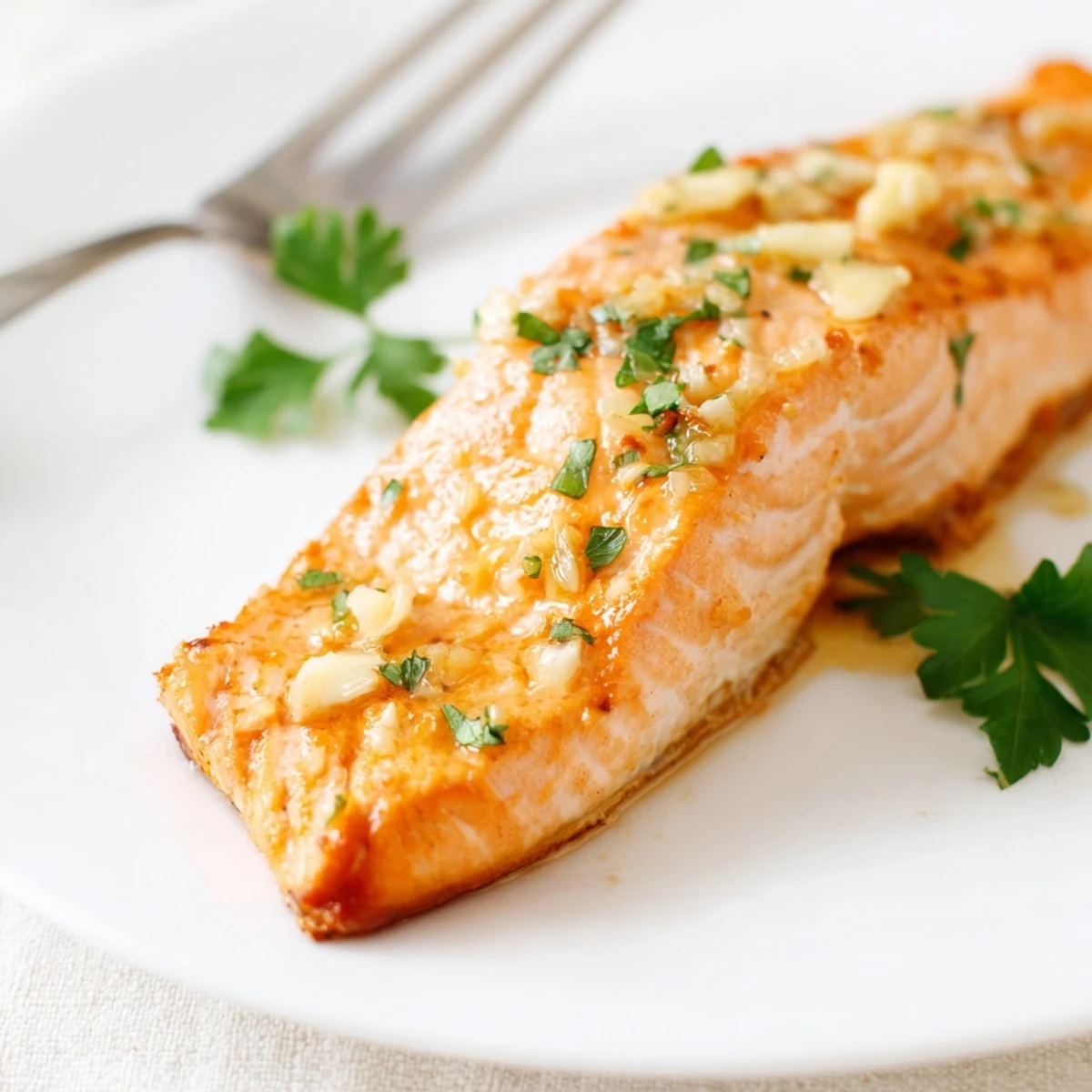 Quickly roasted Honey Garlic Glazed Salmon served hot, ideal for an easy weeknight dinner with steamed vegetables.