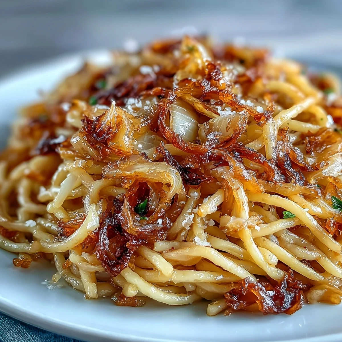 Plate of Cabbage Pasta With Garlic and Parmesan next to a glass of Pinot Grigio, with lemon zest and red pepper flakes.