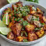 Crispy diced potatoes tossed in smoky Mexican spices and lime, garnished with fresh cilantro for bold street-style flavor.