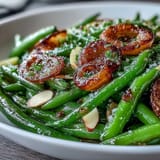 Tender green beans roasted until blistered, tossed with golden garlic and fresh lemon zest for bright flavor.  
