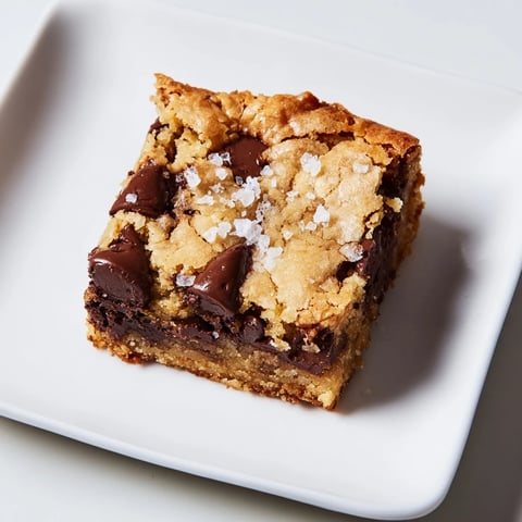 The Ultimate Gooey Chocolate Chip Cookie Bars, warm from the oven, with melting chocolate chips.