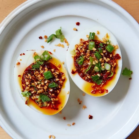 Perfectly jammy Chili Oil Eggs drizzled with vibrant, spicy chili oil for a savory bite.