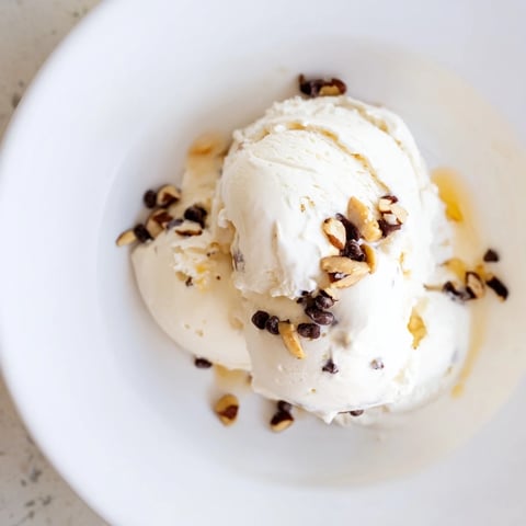 Creamy cottage cheese ice cream, swirled with fresh berries, ready to be scooped and enjoyed.