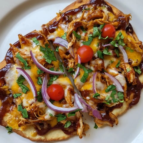 BBQ Chicken Flatbread, a bubbling, cheesy flatbread with flavorful chicken and fresh cilantro garnish.