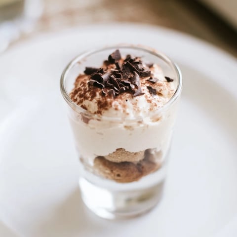 Creamy Deconstructed Tiramisu Shots layered with cocoa, a decadent Italian dessert in small glasses.