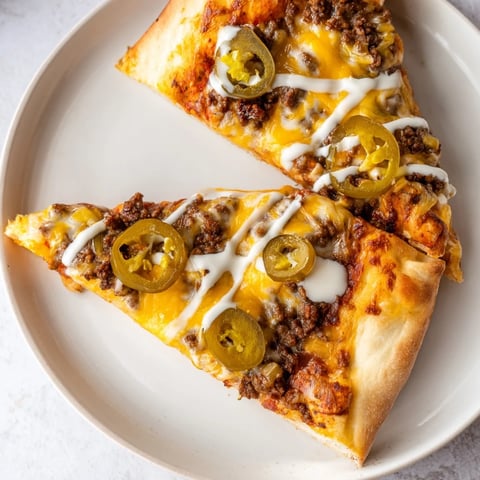 Ground Beef Taco Pizza: A delicious close-up showcases the melted cheese and taco-seasoned ground beef.