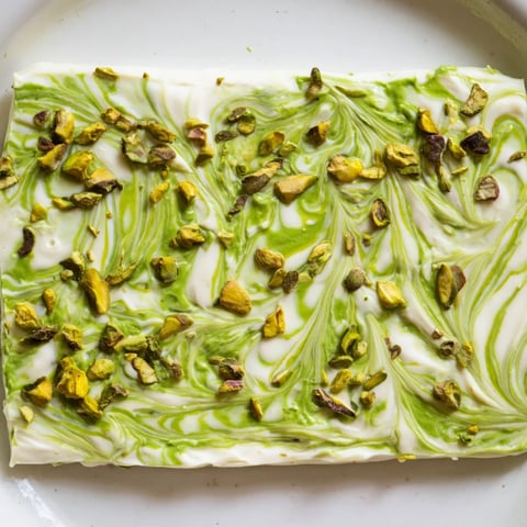 Creamy Pistachio Matcha White Chocolate bark, swirled with matcha and studded with vibrant green pistachios.
