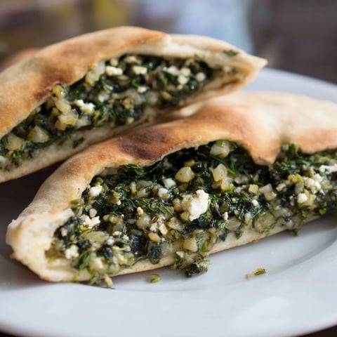 Crispy Turkish Spinach & Feta Flatbread, showcasing golden-brown crust and a savory filling, ready to serve.