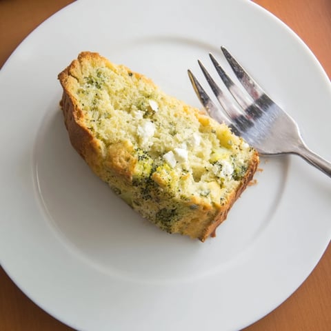 Moist broccoli and feta loaf baked golden-brown, with tender green florets and creamy cheese crumbles visible inside.