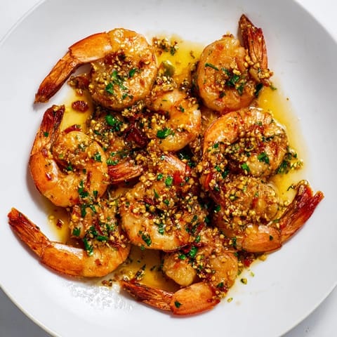 Golden shrimp atop pasta: a delectable 15-Minute Garlic Shrimp Scampi ready to serve and enjoy.