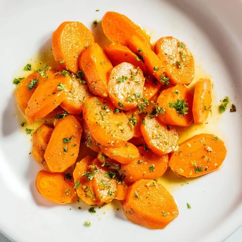 Golden honey-glazed carrots, glistening and tender, ready to be enjoyed as a vibrant side.