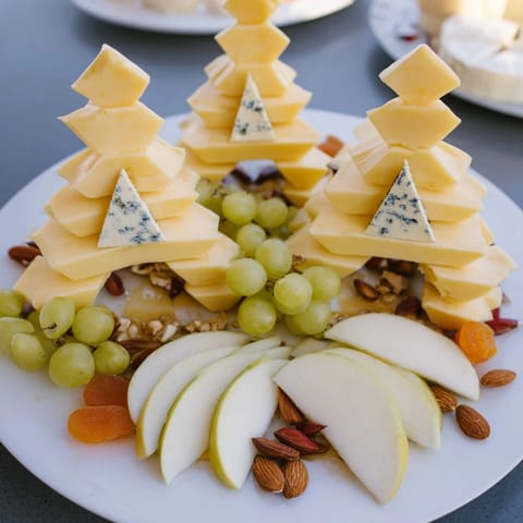 See the elegant Art Deco Arch Cheese Platter gleaming, featuring a variety of cheeses and fresh fruit.