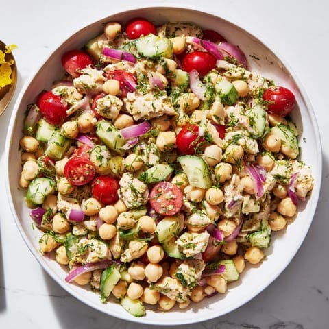 Close-up shot of the flavorful Dense Bean Salad with Lemon-Dill Chicken, drizzled with zesty dressing.