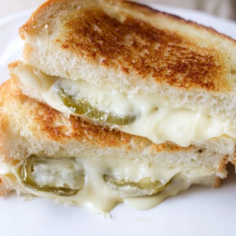 Melted Havarti cheese and fresh jalapeño slices peek out of buttery, golden-brown sourdough bread in this Jalapeño Havarti Grilled Cheese.