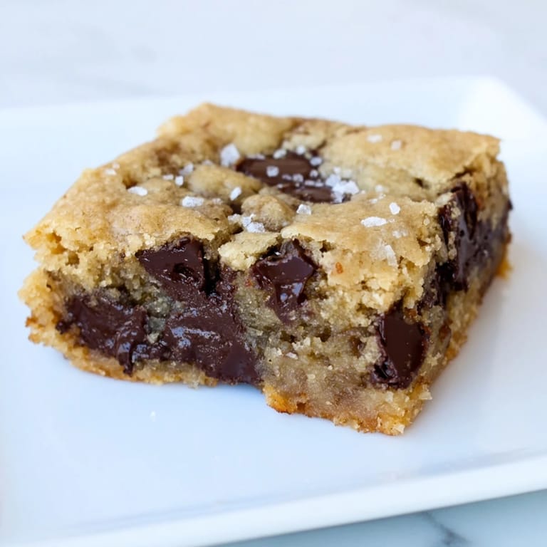 These tempting Ultimate Gooey Chocolate Chip Cookie Bars offer a soft, chewy texture and golden color.