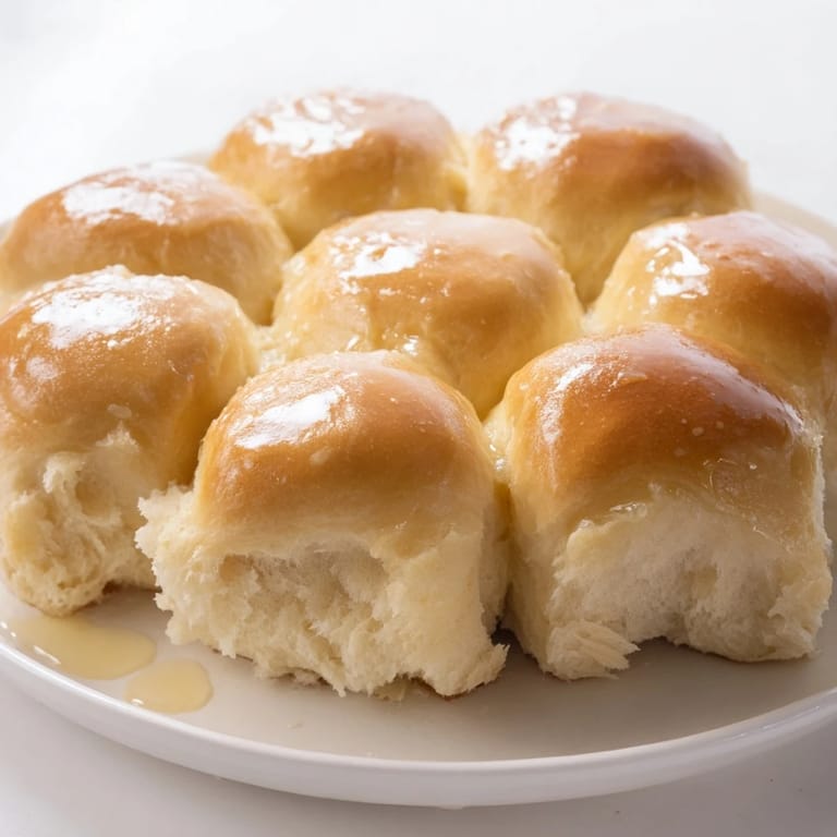 Perfectly baked golden dinner rolls, displayed in a baking dish, ready for a comforting holiday meal.