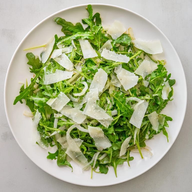 Fresh arugula salad with a tangy lemon dressing, a quick, easy Italian-inspired delight.