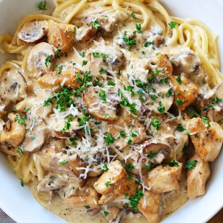 Delicious creamy mushroom chicken pasta, ready to serve, with fresh parsley for visual and flavor appeal.