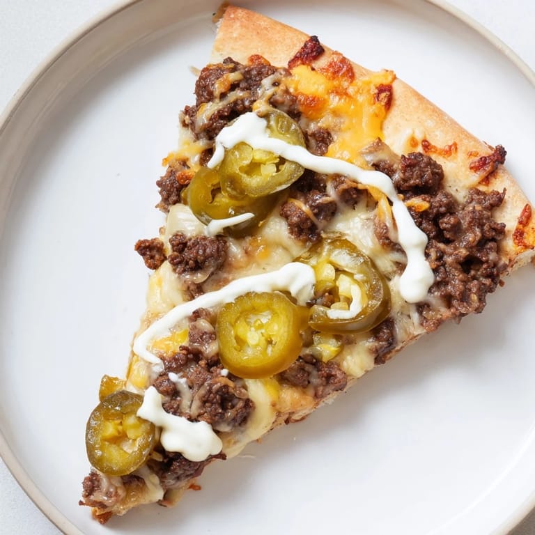 Mouthwatering image of a Ground Beef Taco Pizza, topped with jalapeños and ready to savor the taste.