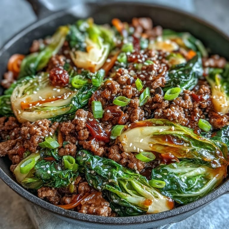 Easy weeknight Chinese Ground Beef and Cabbage Stir-Fry served alongside steamed cauliflower rice for a flavorful, dairy-free meal.